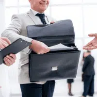 A smiling professional handles legal paperwork, portraying what is a process server visually