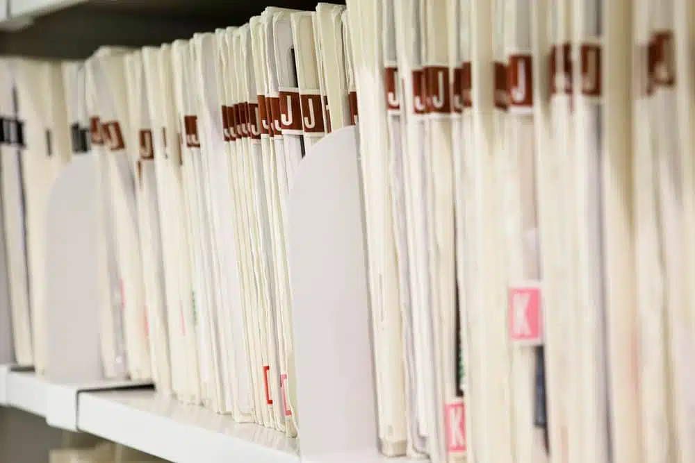 Neatly arranged medical files on shelves showing efficient retrieval of medical record systems