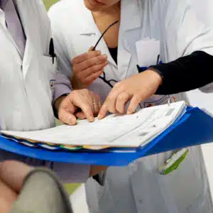 Doctors collaborate while reviewing records, a step critical in retrieval of medical record accuracy