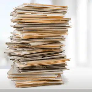 Large stack of files representing examples of notarized documents involved in legal transactions