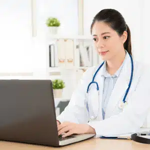 Doctor reviewing digital files to address common problems associated with medical records management