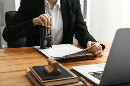 Business professional stamping papers, illustrating examples of notarized documents used for official verification