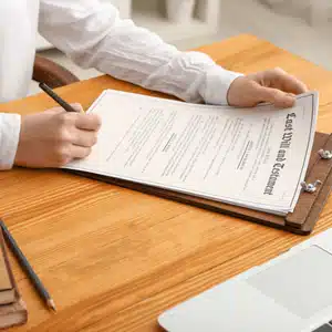 Person signing a will, showcasing examples of notarized documents required for estate planning