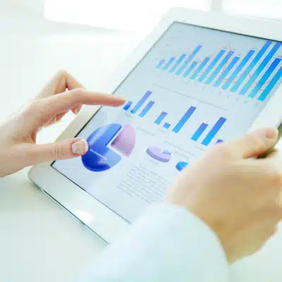 Close-up of hands analyzing bar and pie charts on tablet for legal presentation evidence review