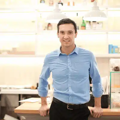 Small business owner smiles confidently after favorable outcome achieved with expert litigation support advisors assistance