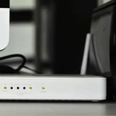 Closeup of network router with lights on in war meeting room supporting secure connections