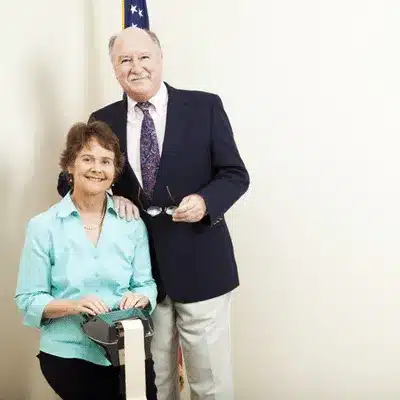 Smiling couple poses for legal case photo, Court reporter Houston prepares notes for deposition session
