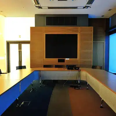 Empty video deposition room with monitors and cables, Court reporter Houston arranges equipment before proceedings