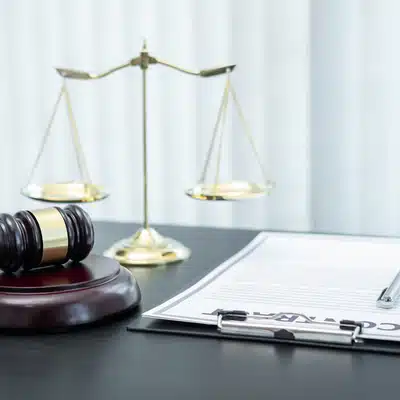 Gavel and justice scales near clipboard contract, representing Court reporter Houston legal documentation services today