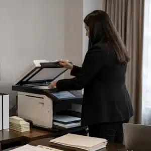 A legal support professional operates a large office scanner as part of legal copy services in marshall tx for trial document preparation